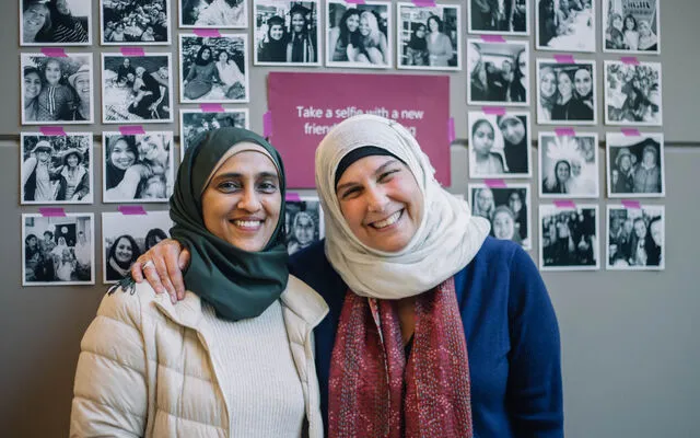 Two women participating in Cultural Conversations pose for a photograph.