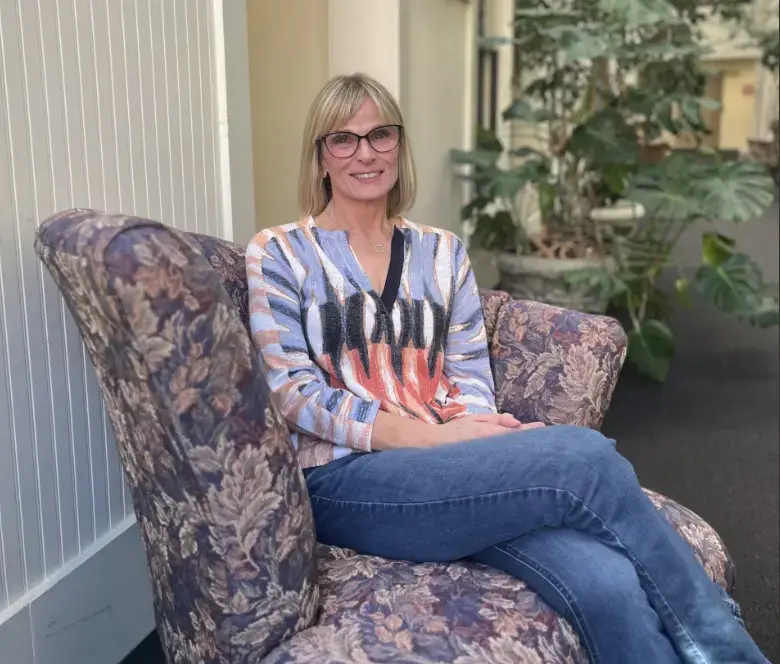 Teenagers and young adults stand in a group discussion