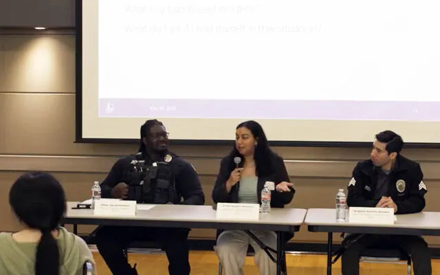 Panelists speak at a meeting about hate crimes and bias incidents.